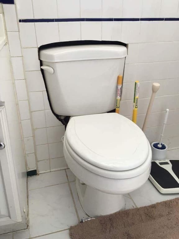 Toilet pan set inside a wall cut-out